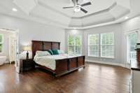 Wake up to sunlight and serenity in the primary suite, complete with soaring ceilings, a wall of windows, and a private door to the balcony.