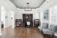 Graceful tray ceilings with scalloped corners add character and charm to this formal dining space (currently used as a home office).