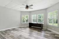 The apartment bedroom features beautiful bay windows that fill the space with natural light.