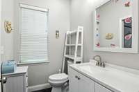This powder room is accessed from bedroom 2.