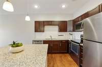 There's plenty of sleek cabinetry for all your storage needs in this kitchen!
