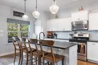 Kitchen also has bright views the the back covered deck.