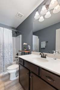 Full bath upstairs with tile floor and combo shower/tub.