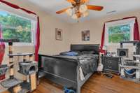 This is Master Bedroom with 2 lovely windows, hardwood flooring, and ceiling fan. Larger space than it appears in picture.
