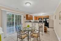 Beautiful Dining area has tile flooring, and overlooks a brand new deck, with view of the trees.