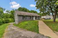 Pull around the back to the 2 car garage. Sidewalk leads straight up to door. Handicap accessible. No steps.