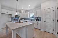 The Harrington Rowhome features 4 bedrooms (One on the main floor), 3.5 baths, 2 car garage and a spacious balcony and covered porch. Photos from a similar plan and are for example only.