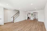 The open layout means you can easily grab a drink in the kitchen without missing the conversations in the living room for game night! Actual photo of home.