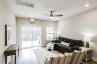 In the living room space, there are sliding doors that will take us out back to enjoy the beautiful lake views!