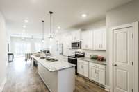 The bright white kitchen is a dream, complete with granite countertops, a stylish tile backsplash,
