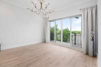 Primary bedroom with a private balcony overlooking the lake