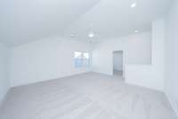 View of bonus looking toward stairs and door to private 5th bedroom/bath