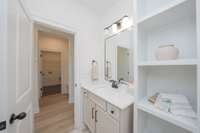 2nd bath down with wood storage shelves