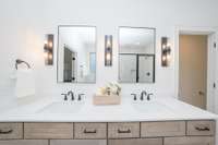 Double sinks with beautiful cabinetry and stylish matte black fixtures