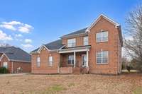 Covered front porch has plenty of room for a seating area and decorations