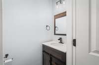 Half bathroom tucked away off the kitchen