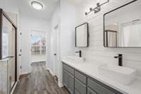 Gorgeous double vanity on the right, garden tub, shower and linen closet on the left