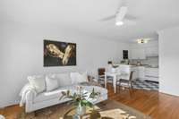 The open-concept layout between the living, dining, and kitchen areas makes everyday living feel effortless.