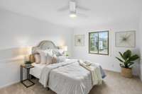 The spacious primary bedroom is filled with soft natural light and a peaceful layout—perfect for everyday comfort.
