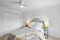 A full wall closet adds practical storage while keeping the room feeling clean and uncluttered.