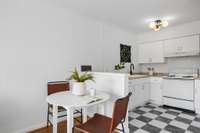 A cozy dining nook just off the kitchen makes the most of the open layout—perfect for casual meals or coffee mornings.