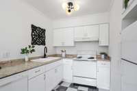 The kitchen is clean and functional with plenty of cabinet storage.