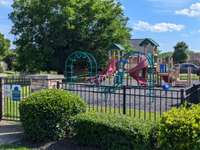 ...Neighborhood Playground - Fully Fenced and Equipped with lots of Climbing & Sliding for active kids!
