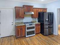 Functional and Inviting Kitchen effectively desinged for practical use and efficiency. NEW HIGH-END Refrigerator with glass door and Range with double ovens!  ( PHOTO EDITED to remove minor objects)