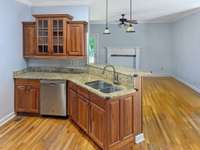 This charming kitchen offers solid wood cabinetry and granite counter tops - quality craftsmanship and thoughtful open design makes entertaining and family gatherings more enjoyable. ( PHOTO EDITED to remove misc. personal items)