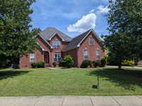 Mature Trees and beautiful brick design with keystones over windows. Private Back yard bordered by mature trees, backing to open field.