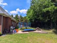 PRIVATE and Spacious Back Yard! Notice the stamped concrete patio with creative shape and privacy tree lined back yard. Whether you are relaxing or entertaining or playing, this back yard is suitable for all your needs.