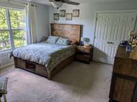 Bedroom #4 with ENSUITE BATHROOM!! Perfect for a TEEN or IN-LAW Suite!  Privately situated at the end of the catwalk on 2nd floor.  Double window adds soft natural lighting and lovely views of the evergreen privacy trees to the side of the home.