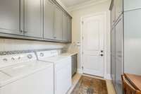 Main Levle Laundry Room with Sink, Built-in Desk, and Spacious Storage Cabinet