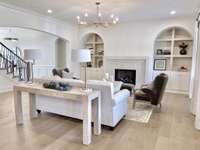 Gather, relax, and unwind in this inviting hearth room, where a beautifully crafted fireplace serves as the heart of the space.