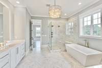 The primary bathroom is a study in grand design, with its expansive layout and sleek design, creating a sense of space and serenity. At the heart of the primary bathroom is a luxurious soaking tub, a centerpiece of relaxation and indulgence.