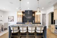 Adjacent to the great room is the gourmet kitchen, which features top-of-the-line appliances, custom cabinetry, and a large center island, making it the ideal setting for culinary adventures and casual gatherings alike.