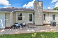 Enjoy that backyard on your oversized patio. There's a separate storage room to the left.