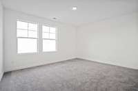 Spacious secondary bedroom.  Colors and selections may vary