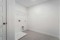 Check out the oversized laundry room with pull down attic storage included