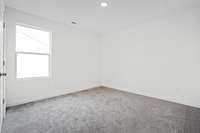 Spacious secondary bedroom.  Colors and selections may vary