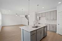 Check out the spacious kitchen with the optional upgraded tall cabinets.  Quartz countertops, tile backsplash, and stainless appliances with gas stove included.  Colors and selections may vary