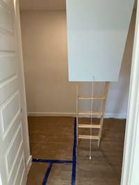 Laundry room with linen closet and also pull down attic storage