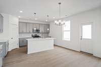 Check out the spacious kitchen with the optional upgraded tall cabinets.  Quartz countertops, tile backsplash, and stainless appliances with gas stove included.  Colors and selections may vary