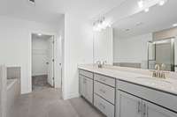 Picture of the Owners bathroom with quartz countertops, dual vanity.  Colors and selections may vary