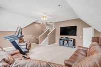 A smaller staircase leads to the two upstairs bedrooms.