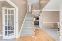 A two-story foyer and hardwood floors welcome you into this turnkey home. Paned glass french doors lead to a home office.