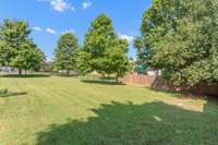 Beautiful mature trees provide shade on those hot summer days. The backyard is almost fenced in, just add a side gate to complete it!