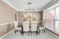 To the right of the foyer is a formal dining room with a butler's pantry/ bar area connecting to kitchen.