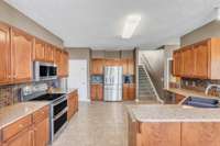 There is ample storage in this generiously sized kitchen! A second staircase leads to the bonus room and two upstairs bedrooms.