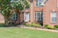 Walk past the meticulously maintained landscaping to a freshly painted front door.